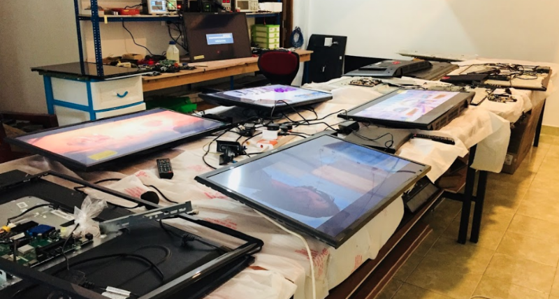 Repair Tronics workshop with multiple TVs being serviced